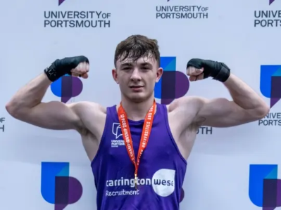 Louis Silk, a university boxer who has just won the BUCS tournament. He wears a medal round his neck and bears the Carrington West logo on his front.