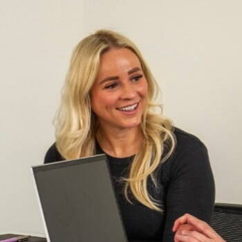 HR Manager smiling with laptop in a meeting